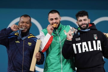 Gold medallist Bulgaria's Karlos May Nasar (C), silver medallist Colombia's Yeison Lopez (L) and bronze medallist Italy's Antonino Pizzolato (R) pose on the podium after the men's -89kg weightlifting event during the Paris 2024 Olympic Games at the South Paris Arena in Paris, on August 9, 2024. (Photo by Dimitar DILKOFF / AFP)