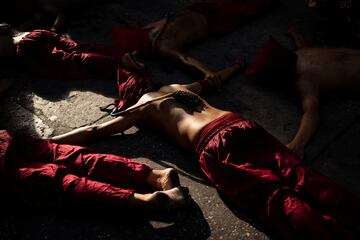 Penitentes filipinos yacen en el suelo mientras se autoflagelan el Jueves Santo en la ciudad de Mandaluyong, Metro Manila, Filipinas.