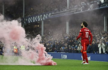 Soccer Football - Premier League - Everton v Liverpool - Goodison Park, Liverpool, Britain - December 1, 2021 Liverpool's Mohamed Salah celebrates scoring their third goal alongside a smoke bomb on the pitch REUTERS/Phil Noble