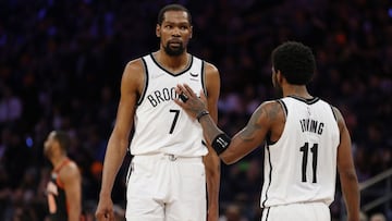 NEW YORK, NEW YORK - APRIL 06: Kyrie Irving #11 reacts with Kevin Durant #7 of the Brooklyn Nets during the second half against the New York Knicks at Madison Square Garden on April 06, 2022 in New York City. The Nets won 110-98. NOTE TO USER: User expressly acknowledges and agrees that, by downloading and or using this photograph, User is consenting to the terms and conditions of the Getty Images License Agreement.   Sarah Stier/Getty Images/AFP
 == FOR NEWSPAPERS, INTERNET, TELCOS &amp; TELEVISION USE ONLY ==