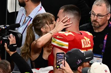 (FILES) US singer-songwriter Taylor Swift kisses Kansas City Chiefs' tight end #87 Travis Kelce after the Chiefs won Super Bowl LVIII against the San Francisco 49ers at Allegiant Stadium in Las Vegas, Nevada, February 11, 2024. Swift is releasing her highly anticipated record "The Tortured Poets Department" on April 29, 2024  -- the 11th studio album from the megastar who is already having a blockbuster year. Swift announced the album's release at the Grammys in February, a night that saw the 34-year-old billionaire win a record-breaking fourth Album of the Year prize. (Photo by Patrick T. Fallon / AFP)