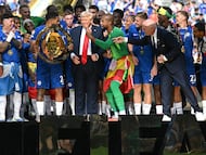 Chelsea's players celebrate with the trophy alongside US President Donald Trump during the award ceremony for the FIFA Club World Cup 2025 Champions, following the final football match between England's Chelsea and France's Paris Saint-Germain at the MetLife Stadium in East Rutherford, New Jersey on July 13, 2025. (Photo by Paul ELLIS / AFP)
