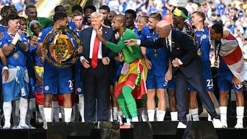 Chelsea's players celebrate with the trophy alongside US President Donald Trump during the award ceremony for the FIFA Club World Cup 2025 Champions, following the final football match between England's Chelsea and France's Paris Saint-Germain at the MetLife Stadium in East Rutherford, New Jersey on July 13, 2025. (Photo by Paul ELLIS / AFP)