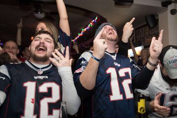 Los aficionados de los Patriots se reunieron en bares para ver el partido mientras comían alitas y bebían cervezas. En la imagen seguidores celebrando el touchdown de Sony Michel.