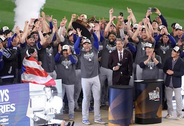 NEW YORK, NEW YORK - OCTOBER 30: Freddie Freeman #5 of the Los Angeles Dodgers celebrates with the MVP trophy with teammates after defeating the New York Yankees 7-6 in game 5 to win the 2024 World Series at Yankee Stadium on October 30, 2024 in the Bronx borough of New York City.   Luke Hales/Getty Images/AFP (Photo by Luke Hales / GETTY IMAGES NORTH AMERICA / Getty Images via AFP)