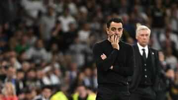 Barcelona's Spanish coach Xavi looks on during the Spanish league football match between Real Madrid CF and FC Barcelona at the Santiago Bernabeu stadium in Madrid on April 21, 2024. Real Madrid won 3-2. (Photo by JAVIER SORIANO / AFP)