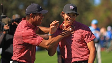 ORLANDO, FLORIDA - DECEMBER 22: Tiger Woods of the United States reacts with his son Charlie Woods after holing out on the fourth hole during the second round of the PNC Championship at Ritz-Carlton Golf Club on December 22, 2024 in Orlando, Florida. Mike Ehrmann/Getty Images/AFP (Photo by Mike Ehrmann / GETTY IMAGES NORTH AMERICA / Getty Images via AFP)