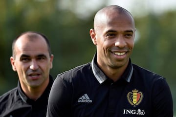 Belgium's new coach Roberto Martinez (L) and assistant Thierry Henry react during a training session. REUTERS/Eric Vidal