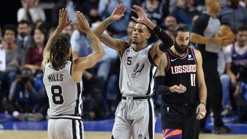 Dec 14, 2019; Mexico City, MEX; San Antonio Spurs guard Patty Mills (8) celebrates with guard Dejounte Murray (5) after making a three-point basket as Phoenix Suns guard Ricky Rubio (11) looks on during overtime at Mexico City Arena. Mandatory Credit: Orlando Ramirez-USA TODAY Sports