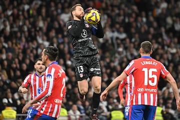 Atletico Madrid's Slovenian goalkeeper #13 Jan Oblak (C) catches the ball during the Spanish league football match between Real Madrid CF and Club Atletico de Madrid at Santiago Bernabeu Stadium in Madrid on February 8, 2025. (Photo by JAVIER SORIANO / AFP)