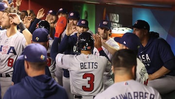 PHOENIX, ARIZONA - MARCH 15: Mookie Betts #3 of Team USA high fives teammates in the dugout after scoring a run against Team Colombia during the fifth inning of the World Baseball Classic Pool C game at Chase Field on March 15, 2023 in Phoenix, Arizona. Christian Petersen/Getty Images/AFP (Photo by Christian Petersen / GETTY IMAGES NORTH AMERICA / Getty Images via AFP)