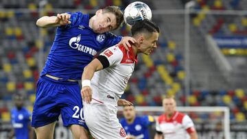 Schalke&#039;s Jonjoe Kenny, left, jumps for a header with Duesseldorf&#039;s Erik Thommy during the German Bundesliga soccer match between Fortuna Duesseldorf and FC Schalke 04 in Duesseldorf, Germany, Wednesday, May 27, 2020. The German Bundesliga becom