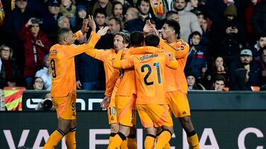 Real Madrid's English midfielder #05 Jude Bellingham (R) celebrates with teammates after scoring his team's second goal during the Spanish league football match between Valencia CF and Real Madrid CF at the Mestalla stadium in Valencia on January 3, 2025. (Photo by JOSE JORDAN / AFP)
