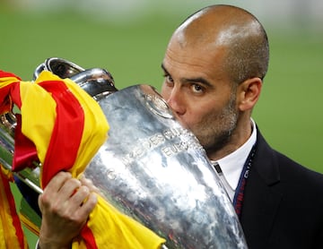 Barcelona's manager Pep Guardiola kisses the trophy after their Champions League final soccer match victory against Manchester United 