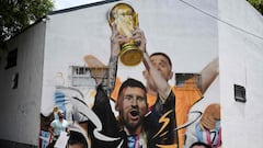 Maxi Bagnasco next to his mural dedicated to Leo Messi.