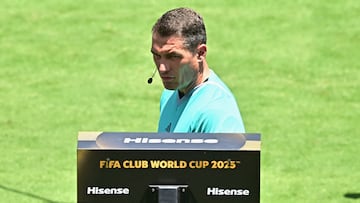 Romanian referee Istvan Kovacs receives video assistance after a goal by Atletico Madrid during the Club World Cup 2025 Group B football match between France's Paris Saint-Germain and Spain's Atletico de Madrid at the Rose Bowl stadium in Los Angeles on June 15, 2025. (Photo by Frederic J. Brown / AFP)