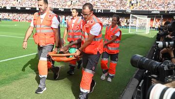 El jugador del Atlético de Madrid Thomas Lemar se va en camilla al lesionarse al apoyar la pierna en un salto. 
