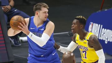 Apr 22, 2021; Dallas, Texas, USA; Dallas Mavericks guard Luka Doncic (77) looks to pass as Los Angeles Lakers guard Dennis Schroder (17) defends during the first quarter at American Airlines Center. Mandatory Credit: Kevin Jairaj-USA TODAY Sports