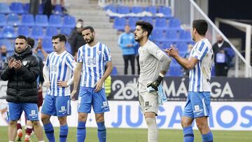 Jugadores del M&aacute;laga cabizbajos tras la derrota contra el Huesca
