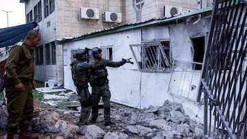 Israeli security officials inspect a damaged house after a barrage of rockets that were launched from the Gaza Strip landed in the Israeli settlement of Beitar Ilit, in the Israeli-occupied West Bank October 9, 2023. REUTERS/Ronen Zvulun