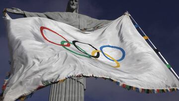 The Olympic flag, in front of the famous statue of Christ the Redeemer in Rio de Janiero.