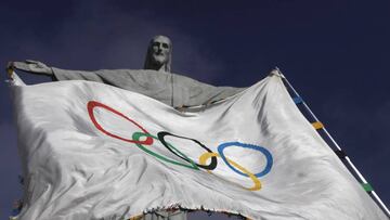 The Olympic flag, in front of the famous statue of Christ the Redeemer in Rio de Janiero.