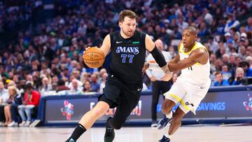 Dallas Mavericks guard Luka Doncic (77) drives to the basket past Utah Jazz guard Kris Dunn (11) during the first half at American Airlines Center.