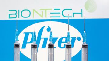 FILE PHOTO: Syringes are seen in front of displayed Biontech and Pfizer logos in this illustration taken November 10, 2020. REUTERS/Dado Ruvic/Illustration/File Photo