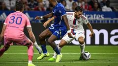 Lyons French midfielder Rayan Cherki (R) fights for the ball with Troyes French defender Yoann Salmier (C) as Troyes' French goalkeeper Gauthier Gallon (L) looks on during the French L1 football match between Olympique Lyonnais (OL) and ES Troyes AC at The Groupama Stadium in Decines-Charpieu, central-eastern France on August 19, 2022. (Photo by JEFF PACHOUD / AFP) (Photo by JEFF PACHOUD/AFP via Getty Images)