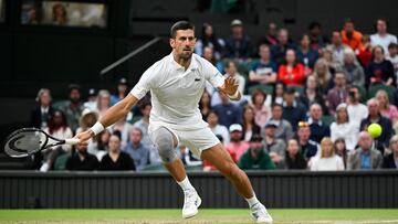 Serbia's Novak Djokovic returns the ball to Australia's Alexei Popyrin during their men's singles tennis match on the sixth day of the 2024 Wimbledon Championships at The All England Lawn Tennis and Croquet Club in Wimbledon, southwest London, on July 6, 2024. (Photo by ANDREJ ISAKOVIC / AFP) / RESTRICTED TO EDITORIAL USE