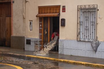 Un hombre achica agua en Llombai, Valencia. El Centro de Coordinación de Emergencias (CCE) ha elevado a rojo el nivel de alerta por lluvias en todo el litoral e interior norte de Valencia.