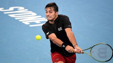 Cristian Garin of Chile hits a return against Norway's Casper Ruud during their Group A men's singles tennis match at the 2022 ATP Cup in Sydney on January 5, 2022. (Photo by Muhammad FAROOQ / AFP) / -- IMAGE RESTRICTED TO EDITORIAL USE - STRICT