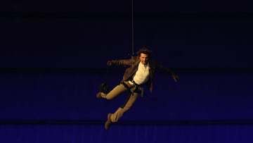 US' actor Tom Cruise lands on the roof of one of the stadium entrances during the closing ceremony of the Paris 2024 Olympic Games at the Stade de France, in Saint-Denis, in the outskirts of Paris, on August 11, 2024. (Photo by Franck FIFE / AFP)