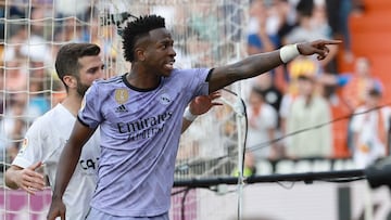 (FILES) Real Madrid's Brazilian forward Vinicius Junior reacts to being insulted pointing at the stands during the Spanish league football match between Valencia CF and Real Madrid CF at the Mestalla stadium in Valencia on May 21, 2023. Spanish prosecutors opened a probe on May 22, 2023 into racist chants aimed at Real Madrid's star forward Vinicius Junior during a match as the football federation president admitted the country had a "problem" with racism. (Photo by JOSE JORDAN / AFP)