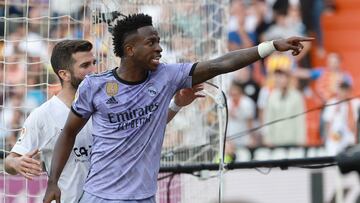 Madrid's Brazilian forward Vinicius Junior reacts to being insulted pointing at the stands during the Spanish league football match between Valencia CF and Real Madrid CF at the Mestalla stadium in Valencia on May 21, 2023.