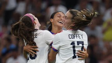 US' forward #11 Sophia Smith (C) is congratulated by US' midfielder #16 Rose Lavelle and US' midfielder #17 Samantha Coffey (R) after scoring in the women's group B football match between the USA and Germany during the Paris 2024 Olympic Games at the Marseille Stadium in Marseille on July 28, 2024. (Photo by Pascal GUYOT / AFP)
