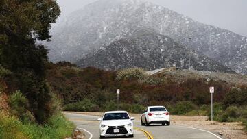 CLAREMONT, CALIFORNIA - FEBRUARY 23: Vehicles drive in the foothills of the San Gabriel Mountains with a dusting of snow in Los Angeles County on February 23, 2023 near Claremont, California. A major storm, carrying a rare blizzard warning for parts of Southern California, is expected to deliver heavy snowfall to the mountains with some snowfall expected to reach lower elevations in L.A. County. (Photo by Mario Tama/Getty Images)