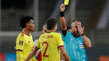 Brazilian referee Wilton Pereira Sampaio shows the yellow card to Colombia's John Medina as he conducts the South American qualification football match for the FIFA World Cup Qatar 2022 between Peru and Colombia at the National Stadium in Lima on Jun