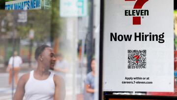 FILE PHOTO: A 7-Eleven convenience store has a sign in the window reading "Now Hiring" in Cambridge, Massachusetts, U.S., July 8, 2022. REUTERS/Brian Snyder/File Photo