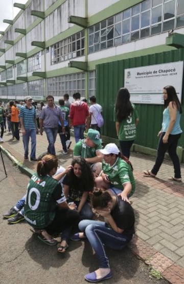 Fans of Brazil's soccer team Chapecoense gather at the Arena Conda stadium in Chapeco, Brazil, Tuesday, Nov. 29, 2016. A chartered plane that was carrying the Brazilian soccer team to the biggest match of its history crashed into a Colombian hillside and broke into pieces, killing 75 people and leaving six survivors, Colombian officials said Tuesday. (AP Photo/Andre Penner)