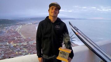 Natxo Gonzalez con su trofeo de tercer clasificado en el Nazar&eacute; Challenge 2017/2018 y su tabla de surf. 