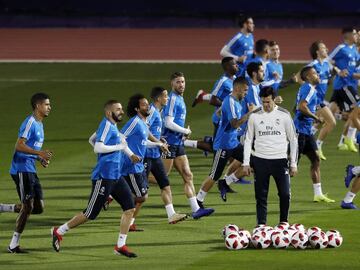 Solari collects the balls as his players do a warm-up run.