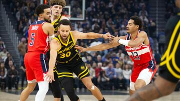 Dec 22, 2023; San Francisco, California, USA; Golden State Warriors guard Stephen Curry (30) dribbles away from pressure by Washington Wizards guard Jordan Poole (13) during the first quarter at Chase Center. Mandatory Credit: D. Ross Cameron-USA TODAY Sports