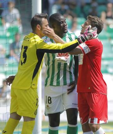 El jugador y portero del Sevilla FC, Carriço (d) y Beto (i) se saludan ante la mirada del jugador del Real Betis, N'Diaye (c), durante el partido correspondiente a la trigesimo tercera jornada de liga, disputado hoy en el estadio Benito Villamarín.