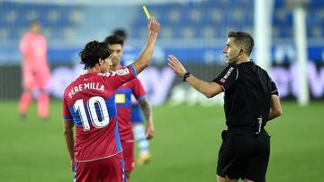 VITORIA-GASTEIZ, SPAIN - OCTOBER 18: Pere Milla of Elche CF shows referee Adrian Cordero Vega his yellow card during the La Liga Santander match between Deportivo Alaves and Elche CF at Estadio de Mendizorroza on October 18, 2020 in Vitoria-Gasteiz, Spain