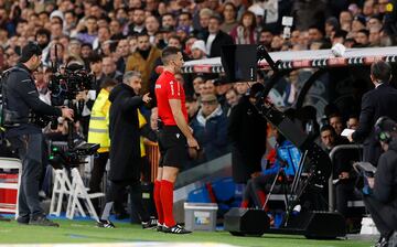 Díaz de Mera observa el VAR, antes de anular el gol de Lucas Vázquez.