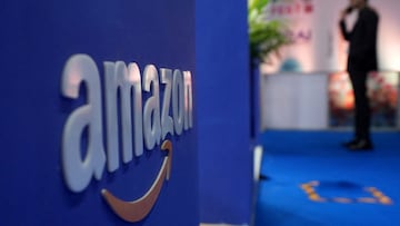FILE PHOTO: A visitior stands near a logo of Amazon during the annual Retail Leadership Summit in Mumbai, India, February 27, 2025. REUTERS/Hemanshi Kamani/File Photo