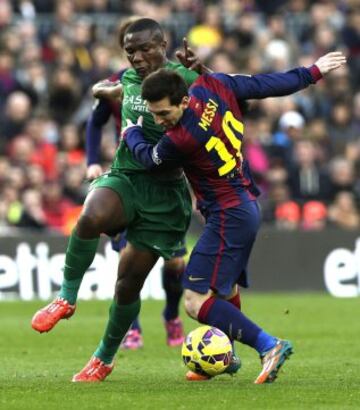 El delantero argentino del FC Barcelona Lionel Messi lucha un balón con el centrocampista mozanbiqueño del Levante Simao Junior durante el partido de la vigésimo tercera jornada de liga de Primera División.
