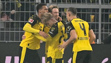 Dortmund's German midfielder #10 Julian Brandt (C) celebrates with teammates scoring his team's first goal during the German first division Bundesliga football match between Borussia Dortmund and Borussia Moenchengladbach in Dortmund on December 19, 2025. (Photo by UWE KRAFT / AFP) / DFL REGULATIONS PROHIBIT ANY USE OF PHOTOGRAPHS AS IMAGE SEQUENCES AND/OR QUASI-VIDEO