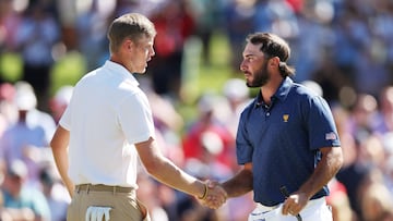 CHARLOTTE, NORTH CAROLINA - SEPTEMBER 24: Cam Davis of Australia and the International Team and Max Homa of the United States Team shake hands after Homa and Tony Finau of the United States Team won 4&3 over Davis and Si Woo Kim of South Korea and the International Team and during Saturday morning foursomes on day three of the 2022 Presidents Cup at Quail Hollow Country Club on September 24, 2022 in Charlotte, North Carolina. Rob Carr/Getty Images/AFP
